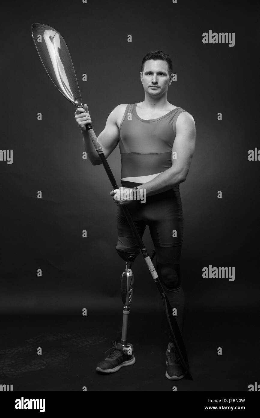 one young adult man only, canoe kayak paddle, athlete sportsman, prosthetic leg, disabled, black and white Stock Photo