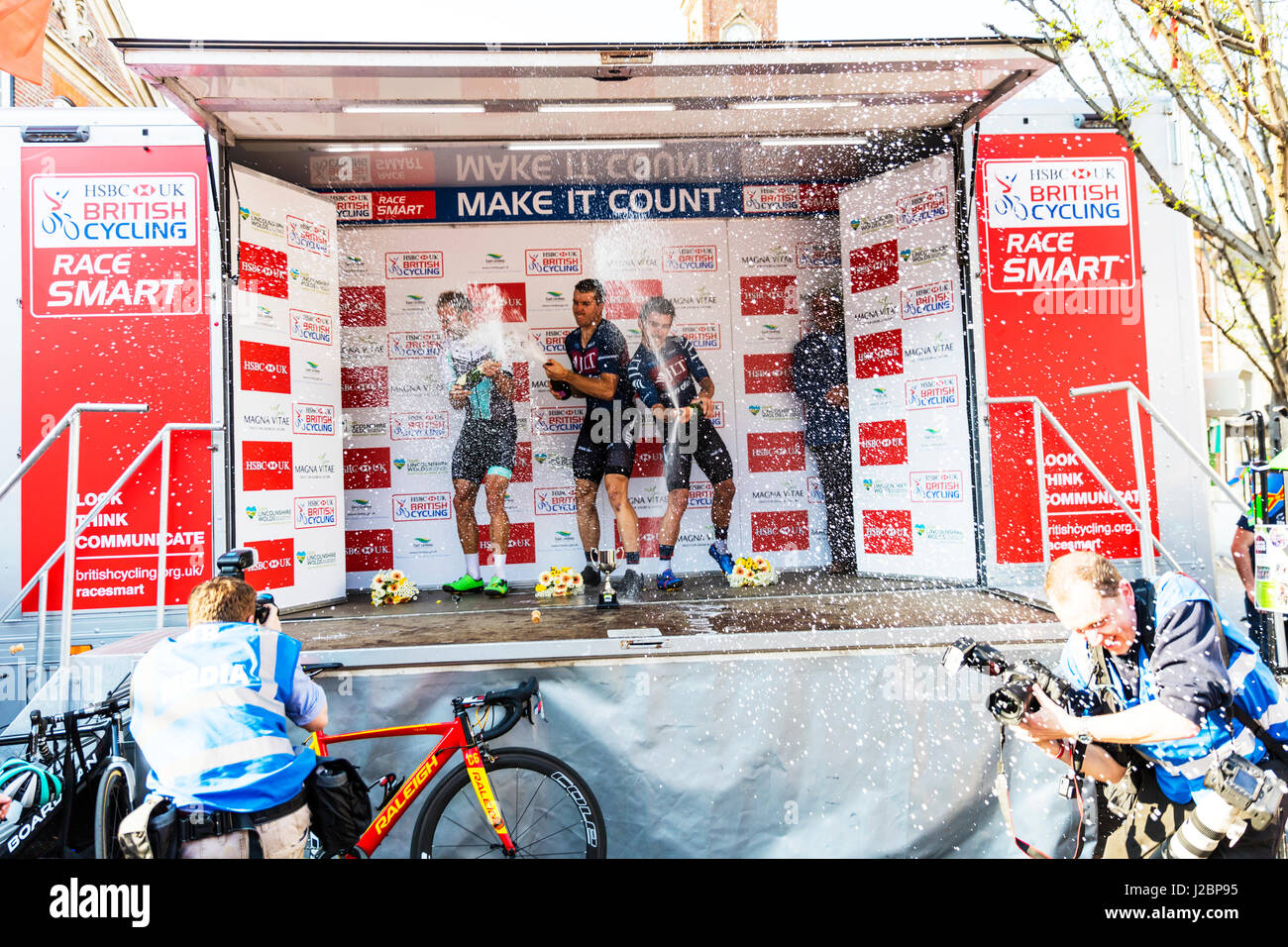 Professional cycling professional cyclists cyclists riders racing race mens race winners podium celebration celebrations spraying champagne Stock Photo