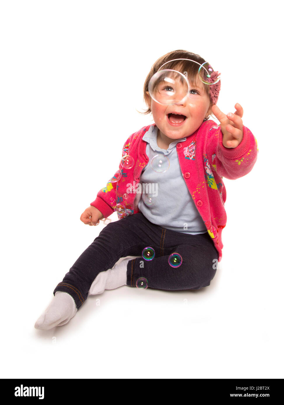 toddler playing with bubbles in a studio Stock Photo