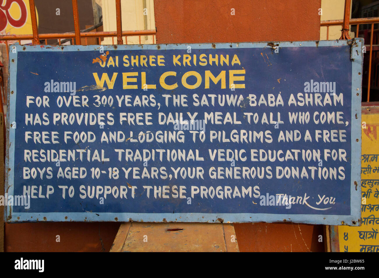 India, Uttar Pradesh, Varanasi. Sign welcoming pilgrims to the ashram ...