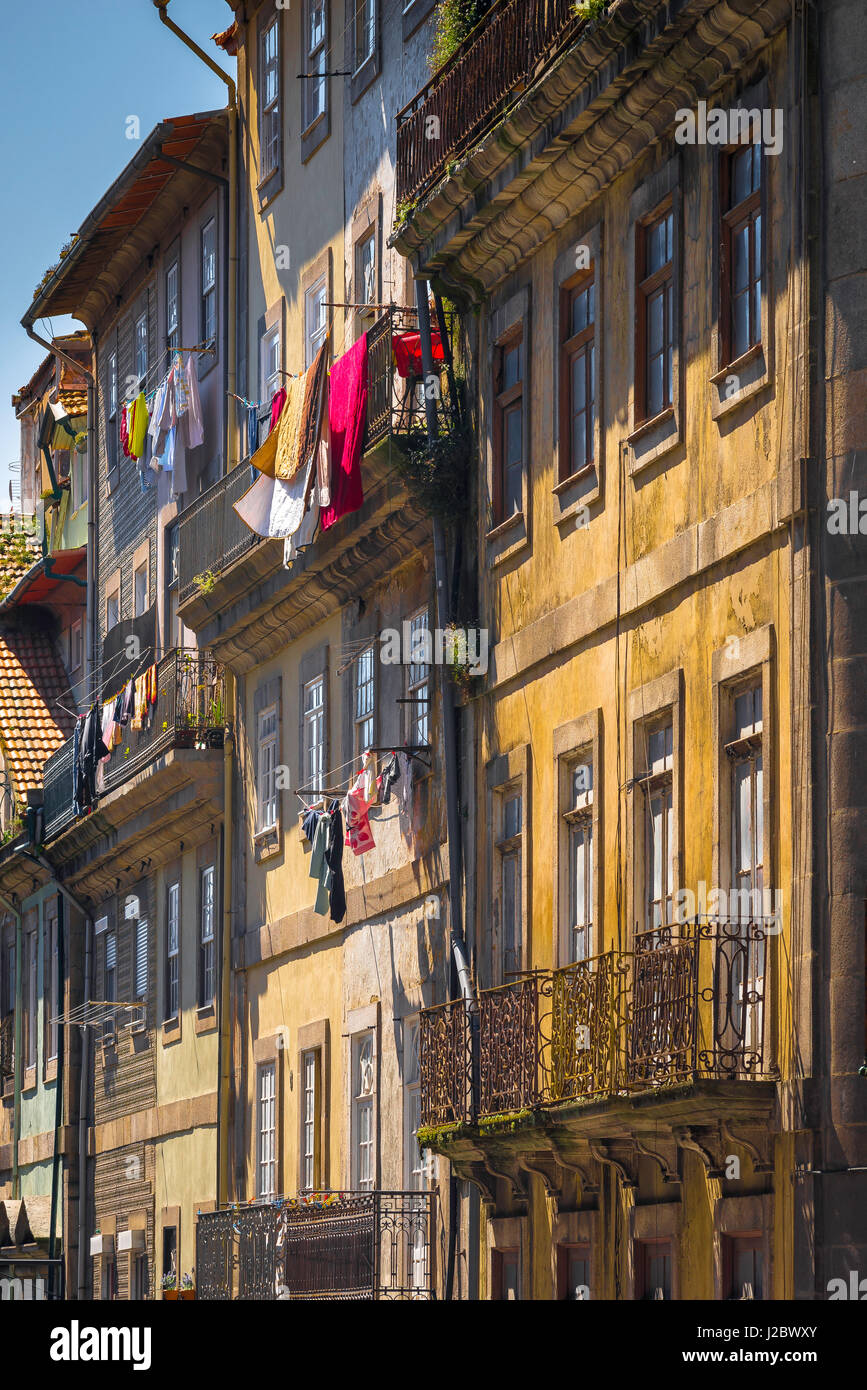 Porto Portugal street, view of laundry hanging from the balconies of apartments in a street in the Ribeira old town area of Porto, Portugal. Stock Photo