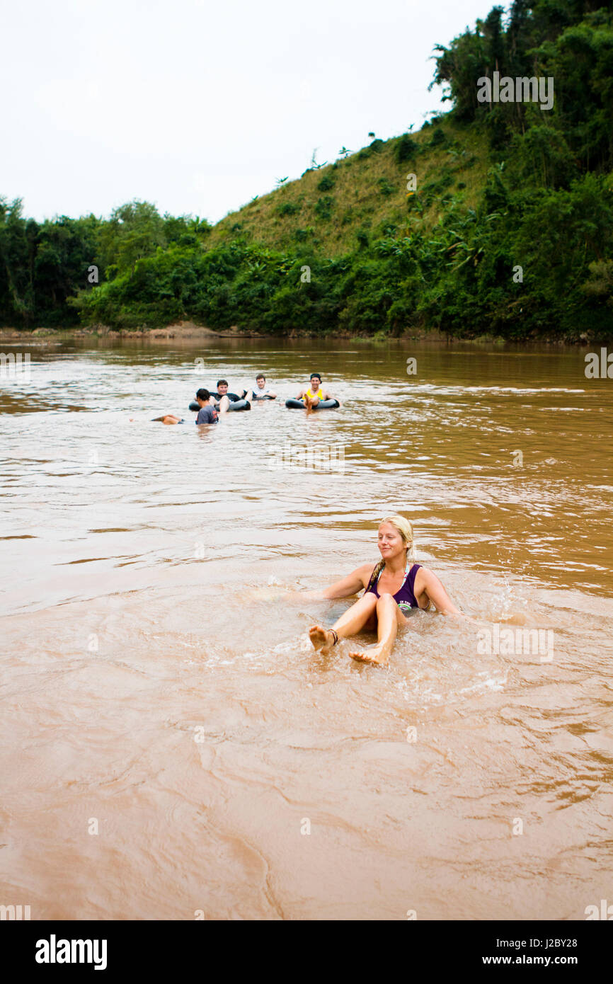 An afternoon trip of tubing down the Ou river is a great way to see the Nong Khiaw valley. (MR) Stock Photo