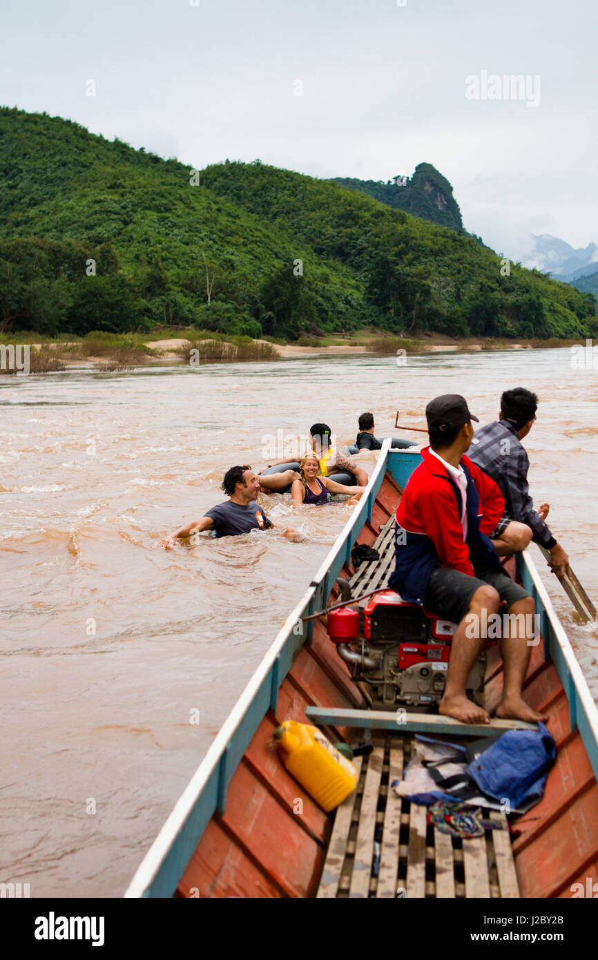 An afternoon trip of tubing and fishing down the Ou river is a great way to see the Nong Khiaw valley. (MR) Stock Photo