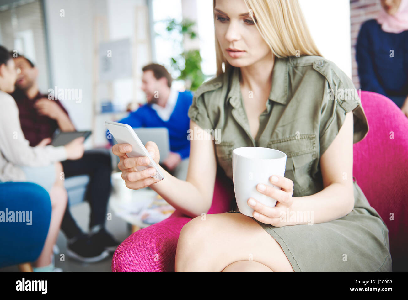 Business woman using cell phone over work Stock Photo