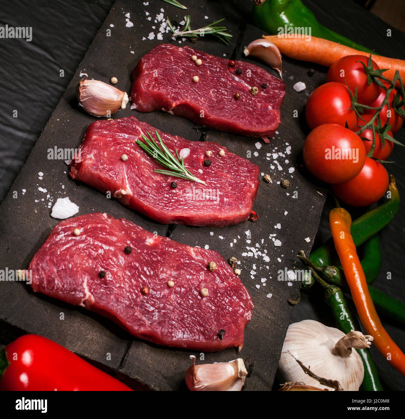 Raw Meat Raw Beef Steak On A Cutting Board With Herbs And Stock Photo Alamy