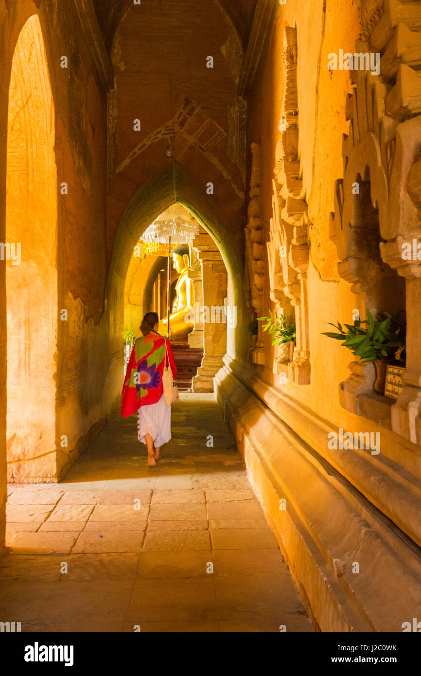 Myanmar. Bagan. Htilominlo Temple. Woman walking through the corridor. Stock Photo