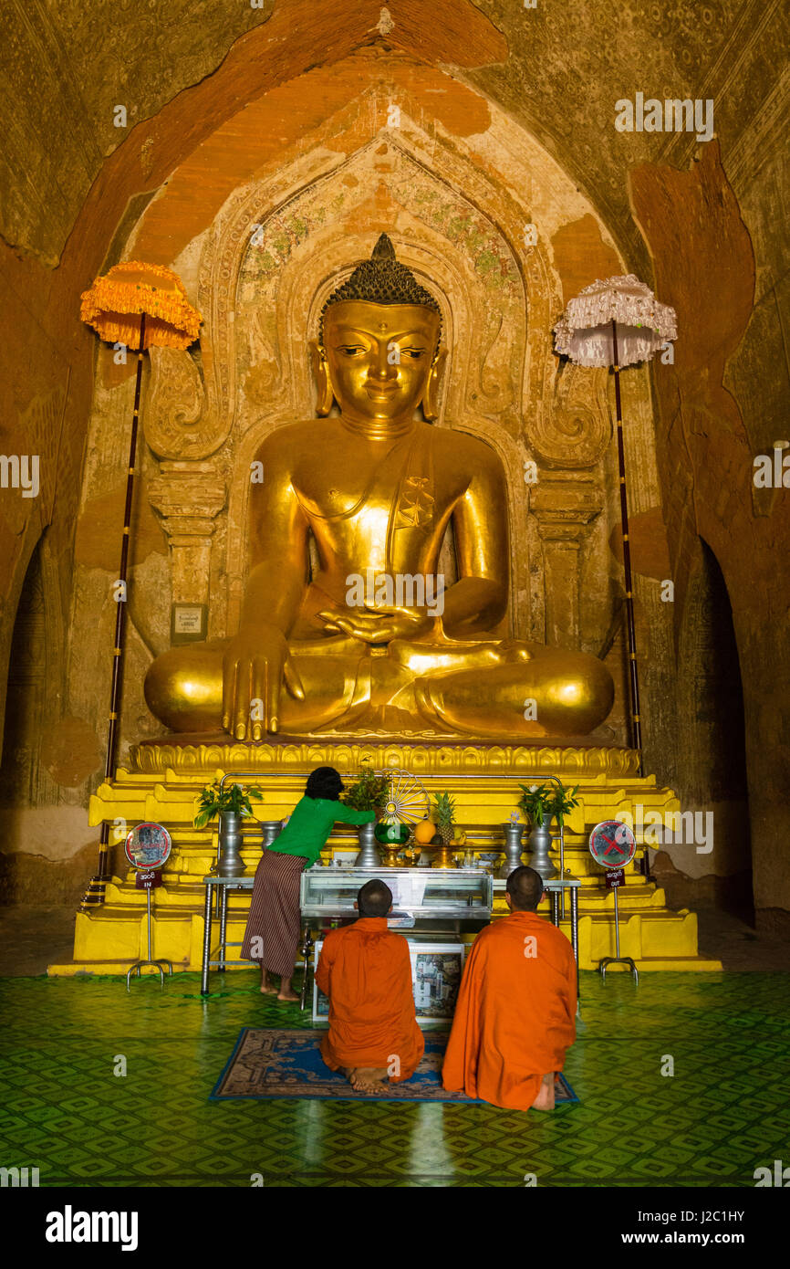 Myanmar. Bagan. Htilominlo Temple. Monks worshipping in the temple. Stock Photo