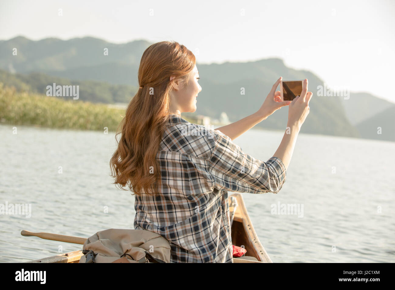 Young female traveler taking pictures Stock Photo