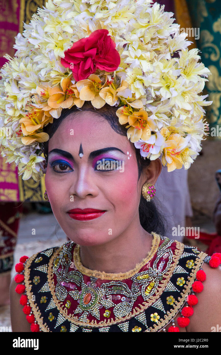 Indonesia, Bali. Female Legong dancer in full makeup and crown of Frangipani flowers before the Legong Dance. (Editorial Use Only) Stock Photo