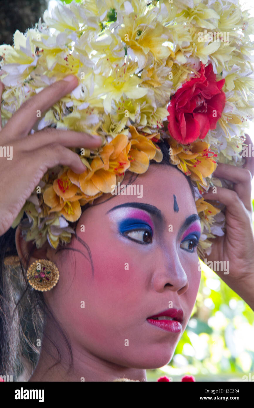 Indonesia, Bali. Female dancer getting her crown of Frangipani flowers adjusted before the Legong Dance. (Editorial Use Only) Stock Photo
