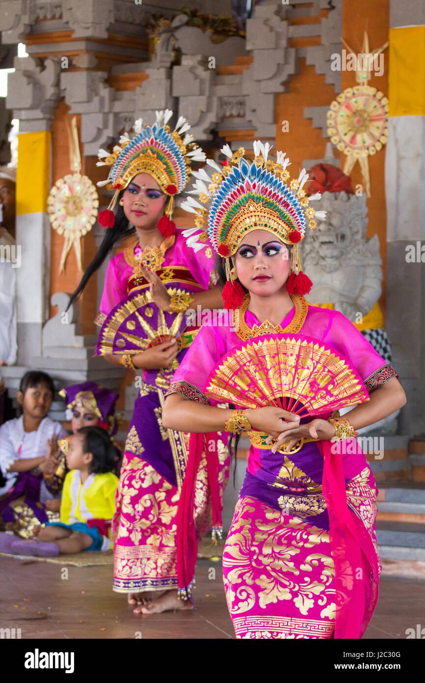 Indonesia, Girls Dressed in Traditional Dancing Costume, Legong Dancers with Frangipani floral headdress. (Editorial Use Only) Stock Photo