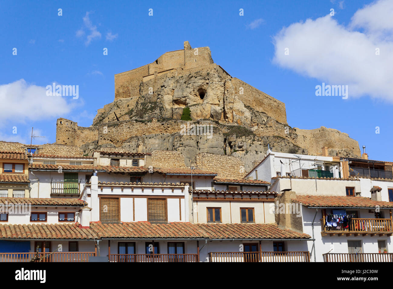 Morella Castle sitting high over Plaze de L'Estudi in the walled city. Stock Photo