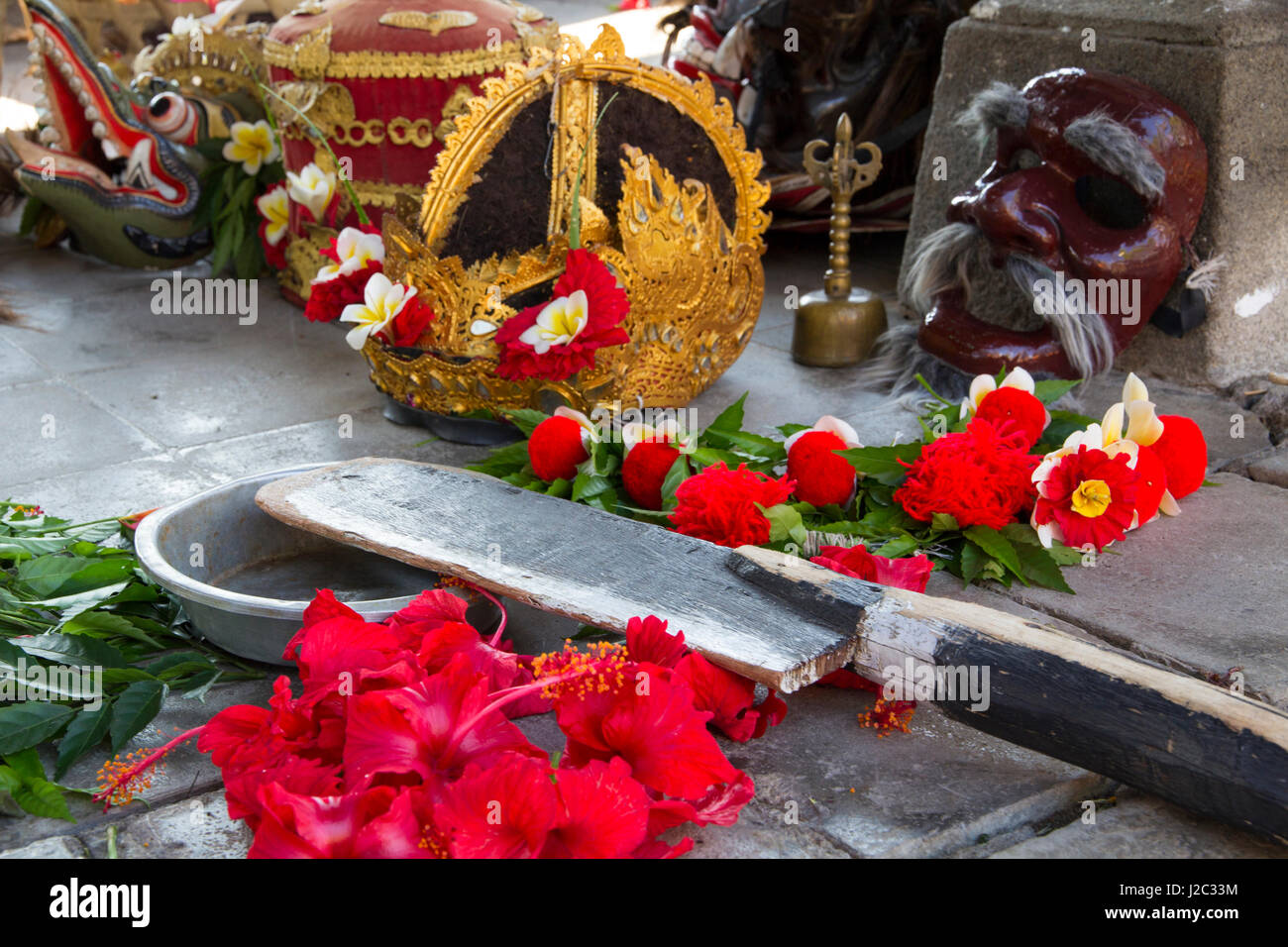 Indonesia, Bali. Balinese Legong and Barong ceremonial headdresses decorated with red Hibiscus and Frangipani flowers in Bali, Indonesia. Stock Photo