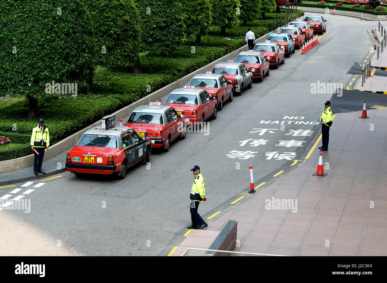 Hong Kong taxi rank outside a hotel with security guards. Stock Photo