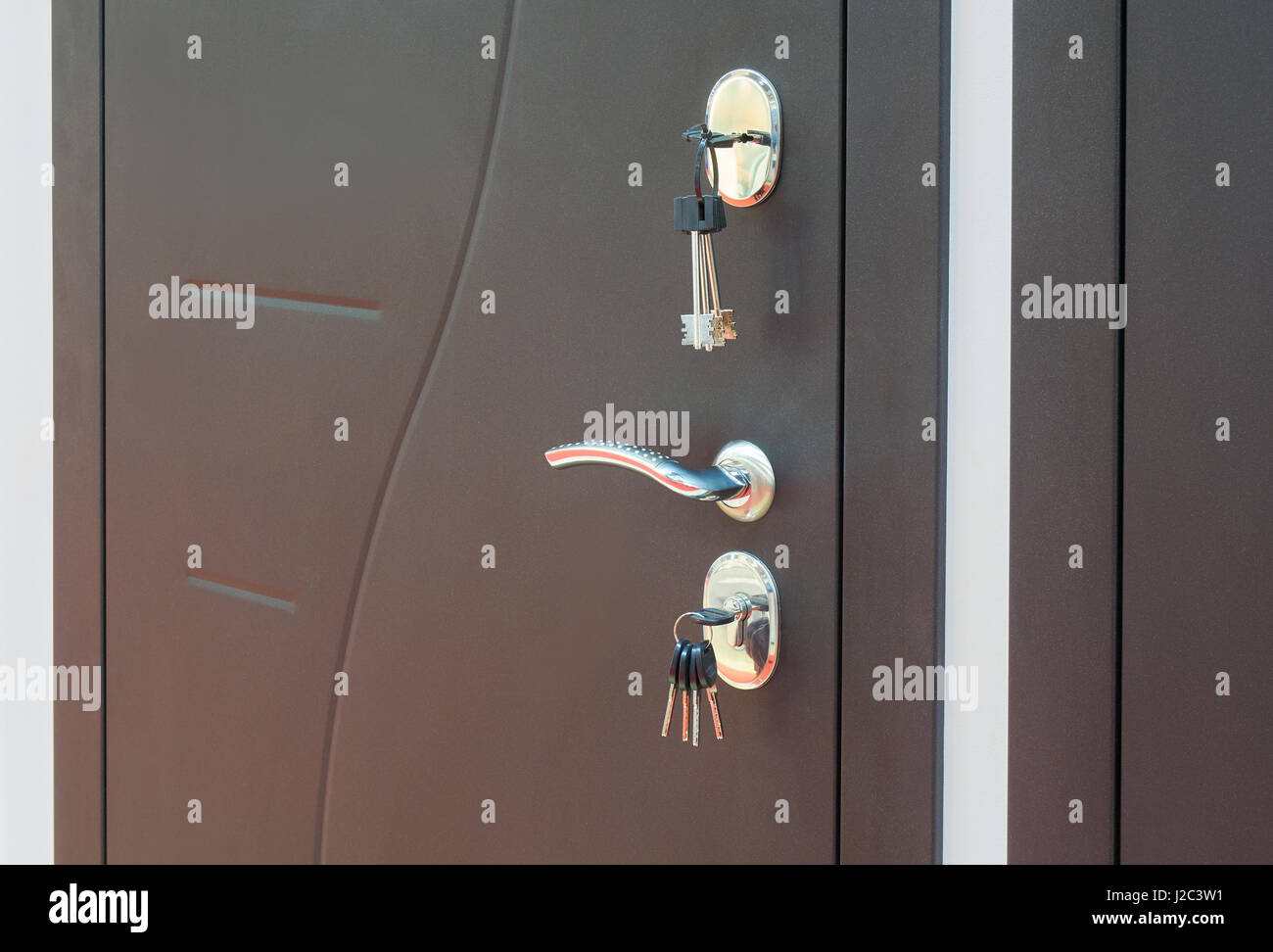 Exterior metal door with keys in the locks Stock Photo Alamy