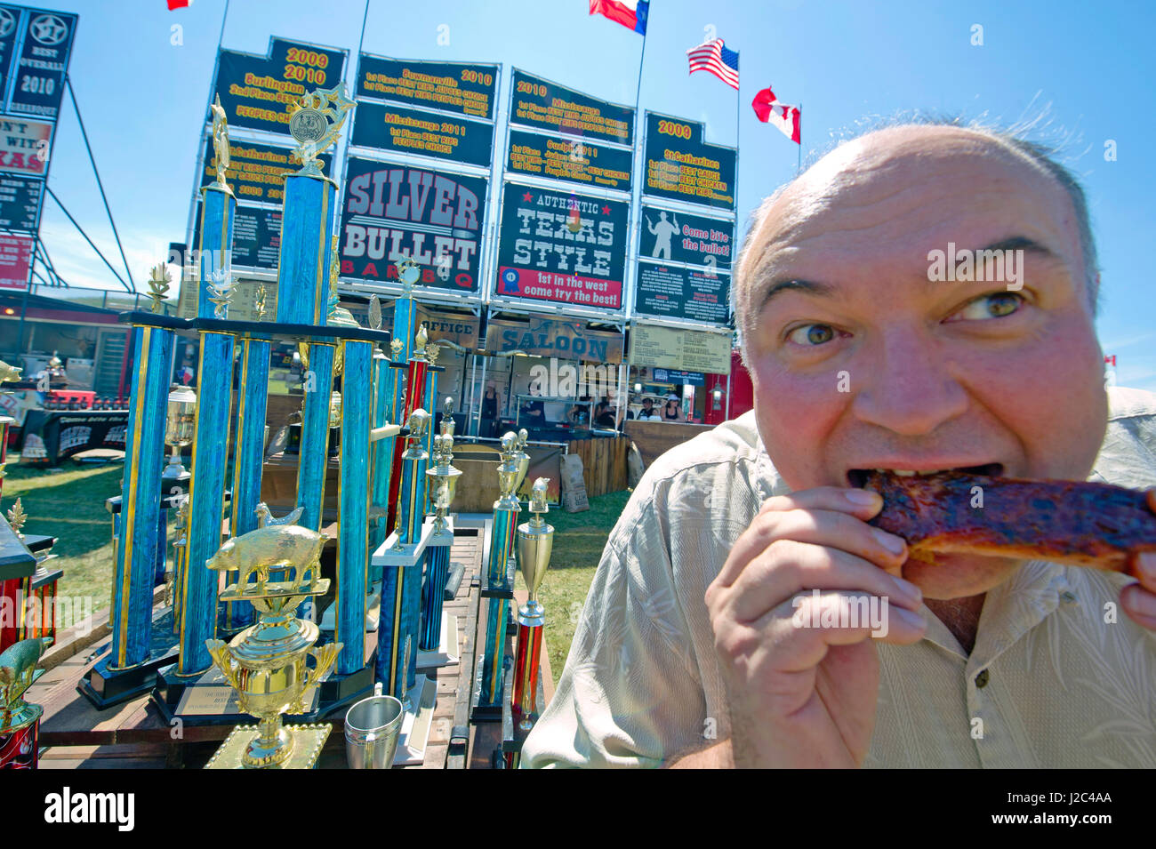A visitor enjoys pork ribs at Toronto ribfest. The festival attracted