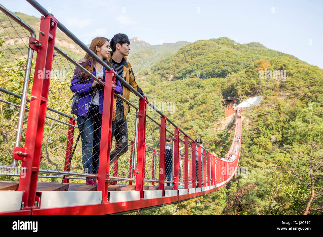 Couple trekkers on bridge hi-res stock photography and images - Alamy