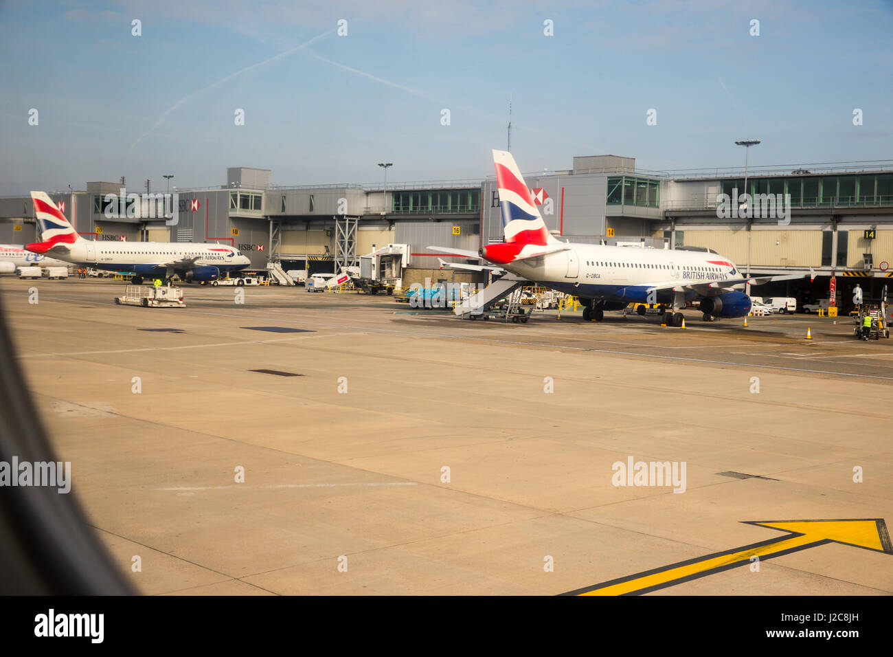 View of British Airways aircraft at the hangers at Gatwick airport prior to take off.View from an airplane that has commenced taxiing on the runway Stock Photo