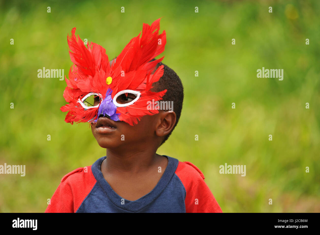 Dominica, Carib Territory, portrait of boy disguised with colorful mask ...