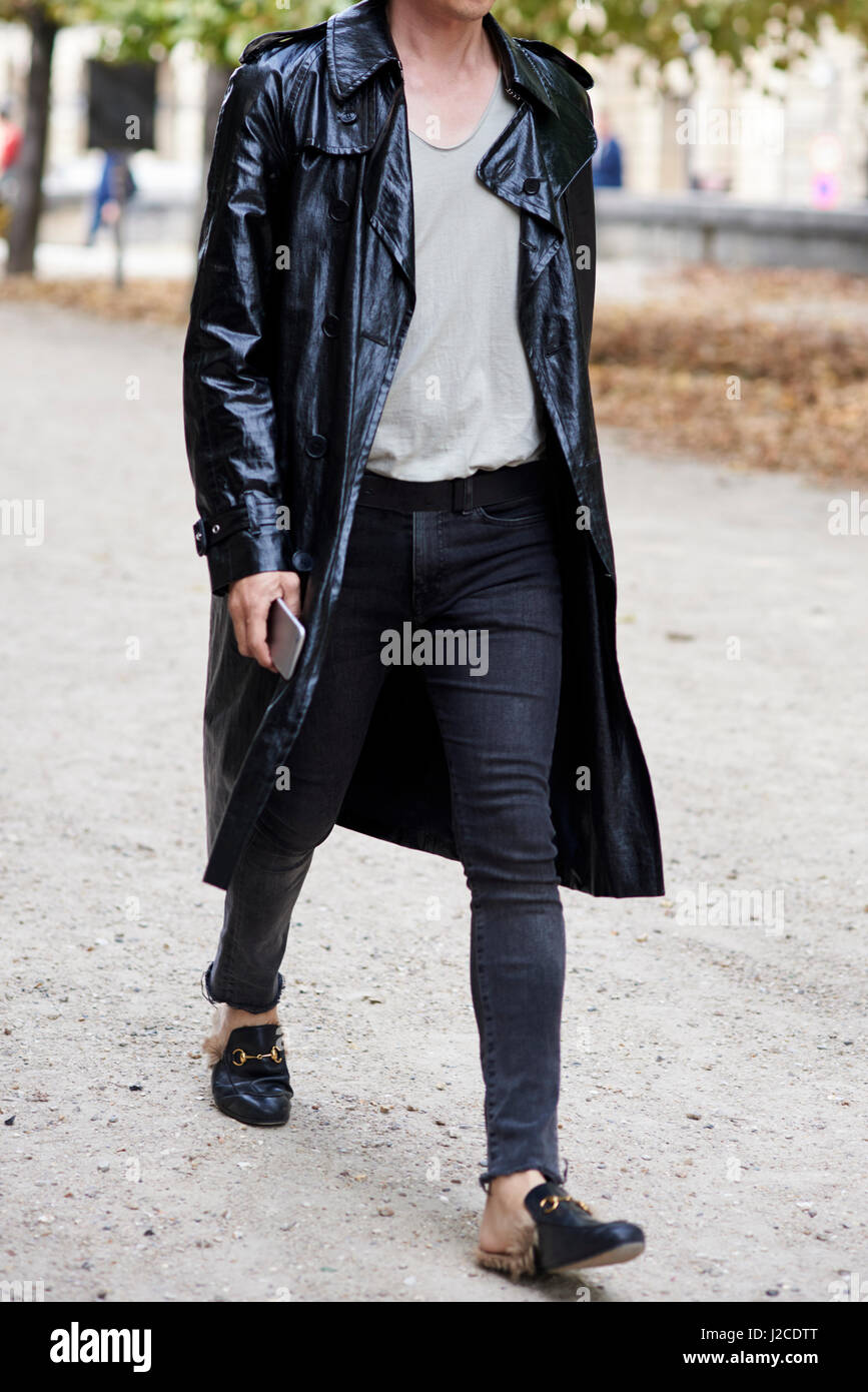 Man in black leather trench coat walking in street, crop Stock Photo - Alamy