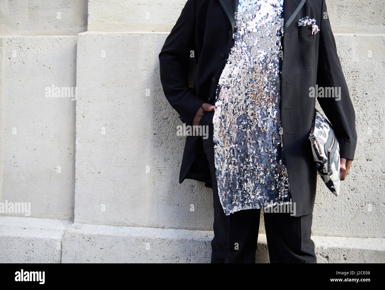 Woman in black suit and sequinned silver tunic, mid section Stock Photo