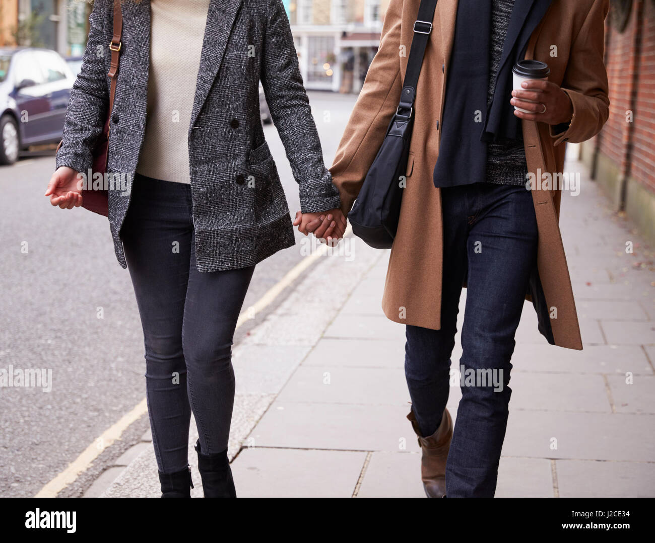 Close Up Of Romantic Couple Walking On Fall Street In City Stock Photo