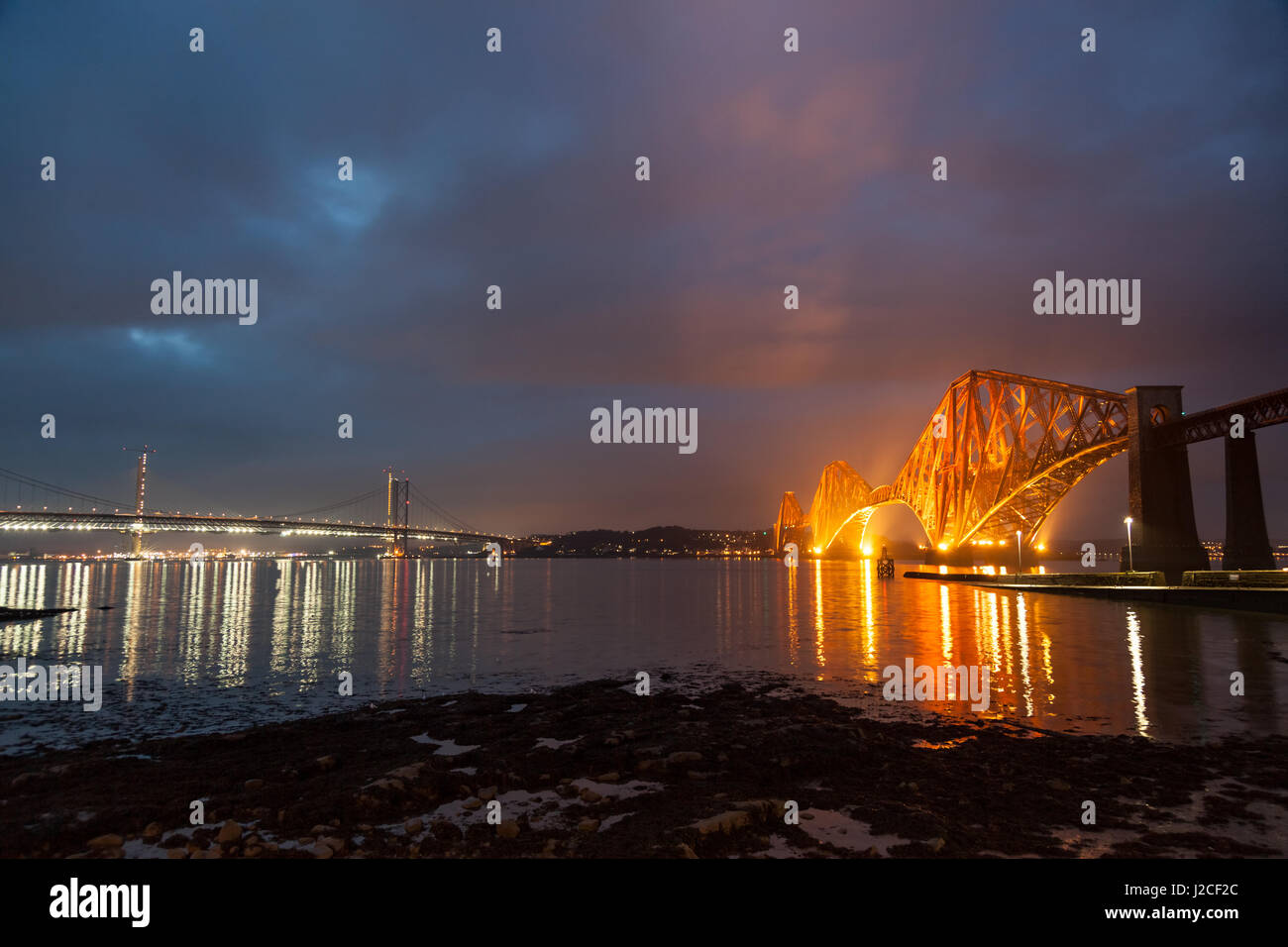 The iconic Forth Rail Bridge lit up at dusk. South Queensferry