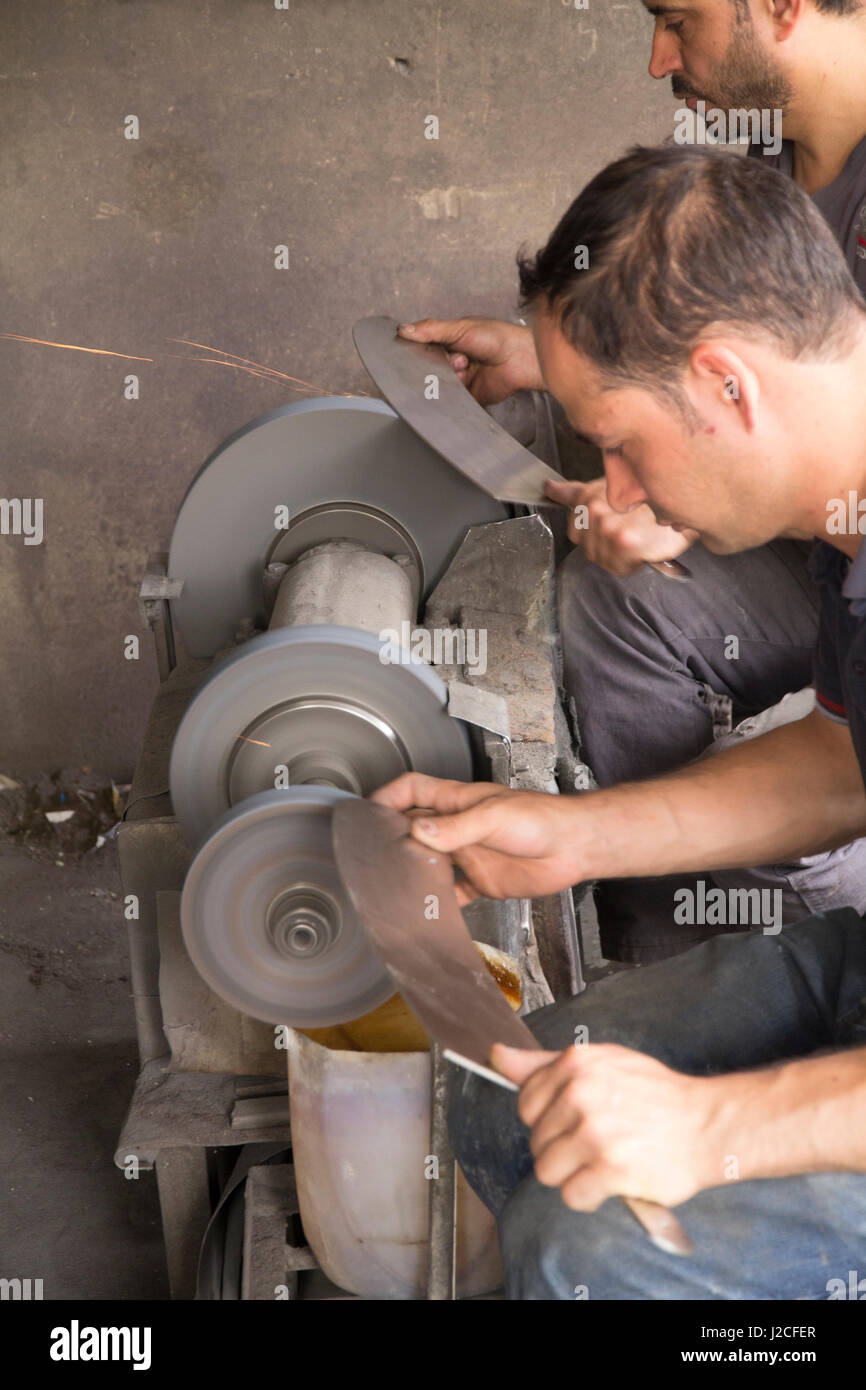 knife sharpening machine and master. Grinding machine. grinding knife using  abrasive stone Stock Photo - Alamy