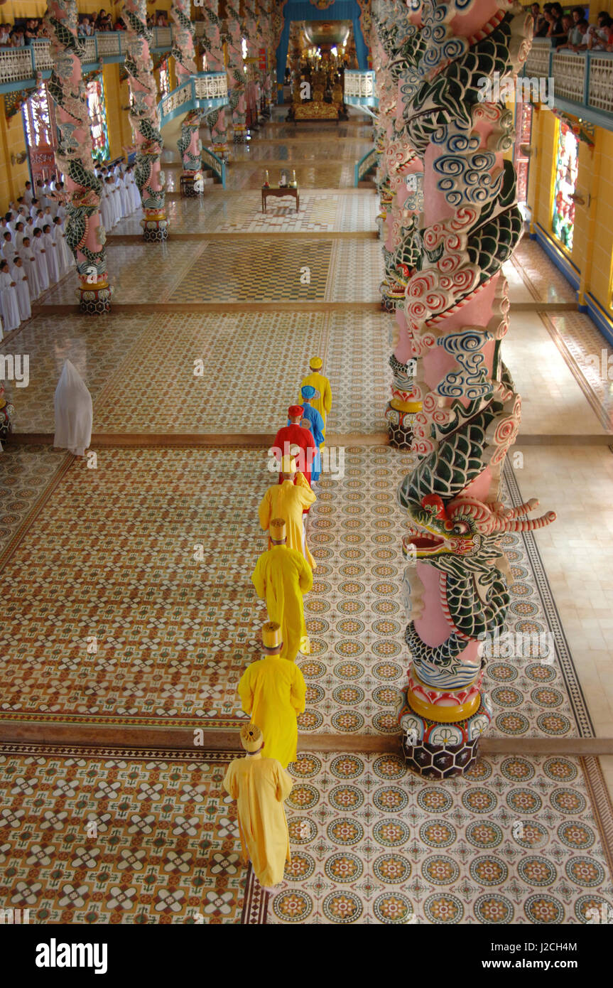 Asia, Vietnam. Worshipers entering Cao Dai Temple, Tay Ninh Stock Photo