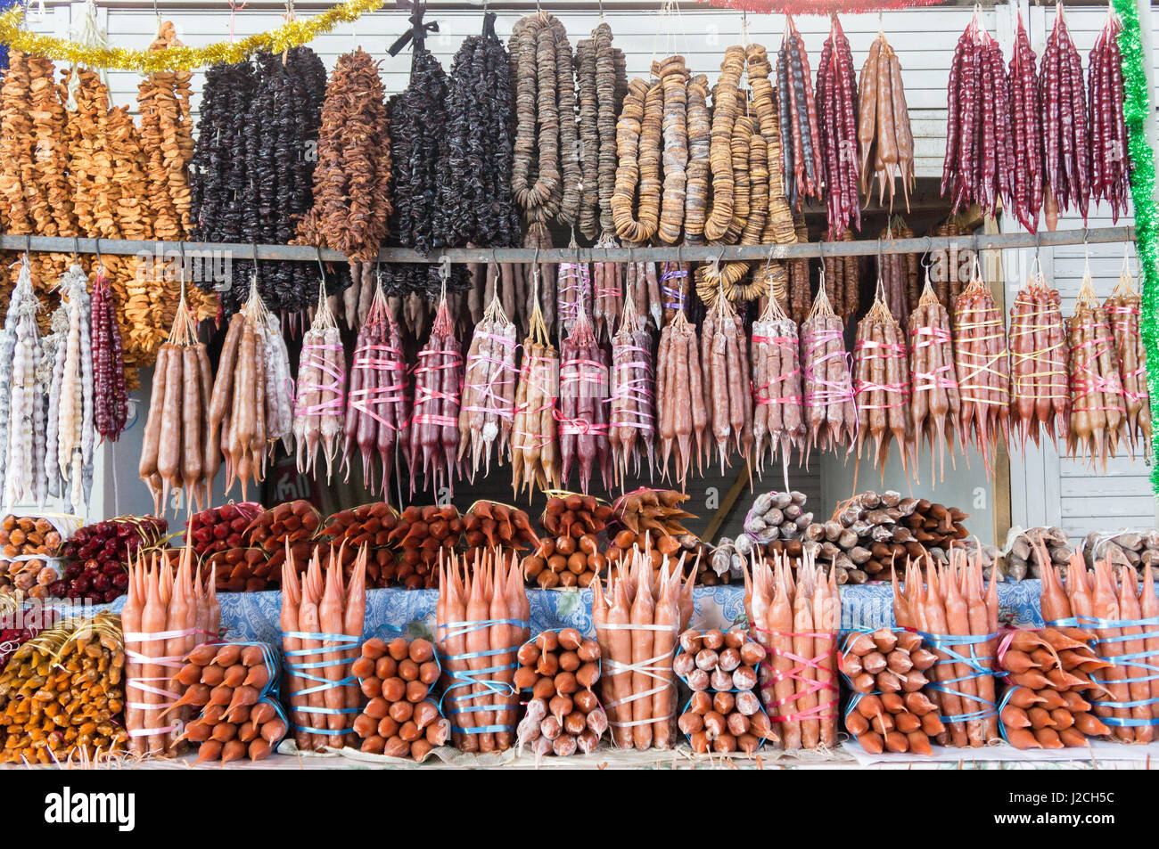 Tbilisi, typical candy from walnuts and grape juice "Churtschchela" on the