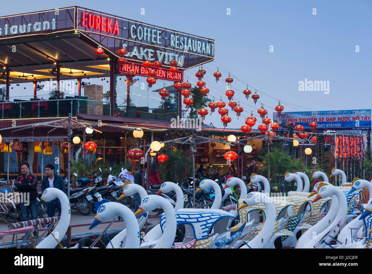 Vietnam, Hanoi. Tay Ho, West Lake, floating restaurant and swan boats, dusk Stock Photo
