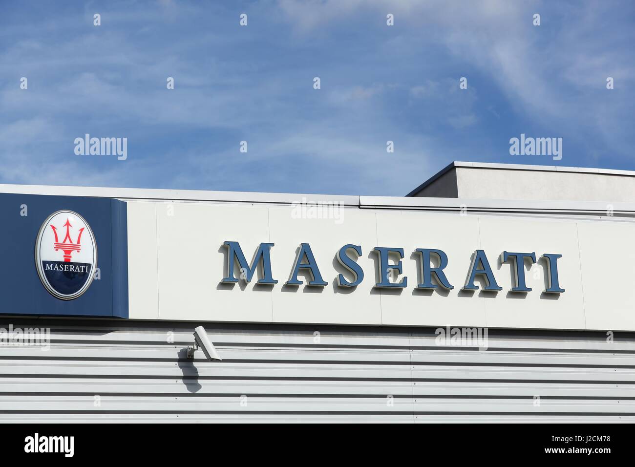 Lyon, France - September 25, 2015: Maserati logo on a wall. Maserati is an Italian luxury vehicle manufacturer established in Italy Stock Photo