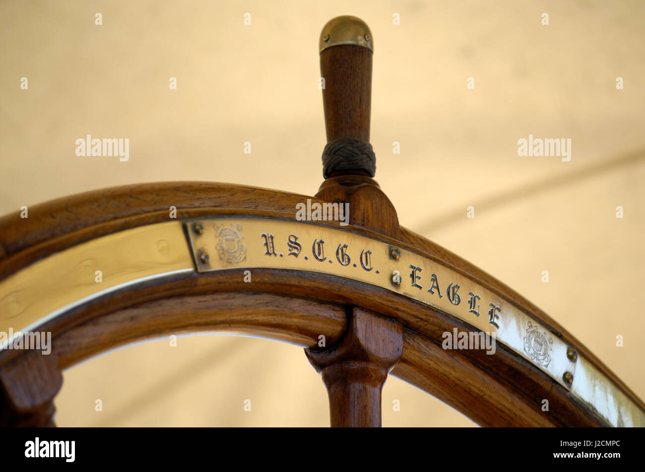 Canada, British Columbia, Victoria. Brass and wood steering wheel on the USCG Eagle is a three-masted sailing barque home ported at the Coast Guard Academy in New London, Connecticut Stock Photo