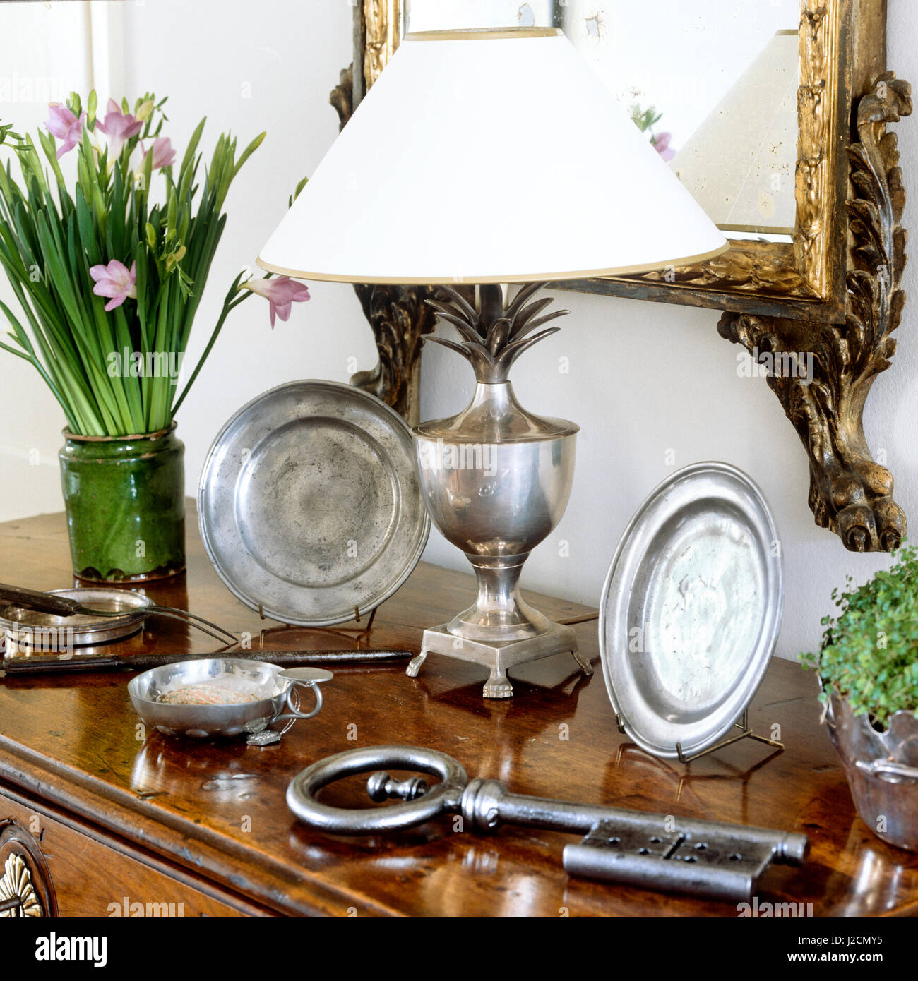 Silver tableware and table lamp. Stock Photo