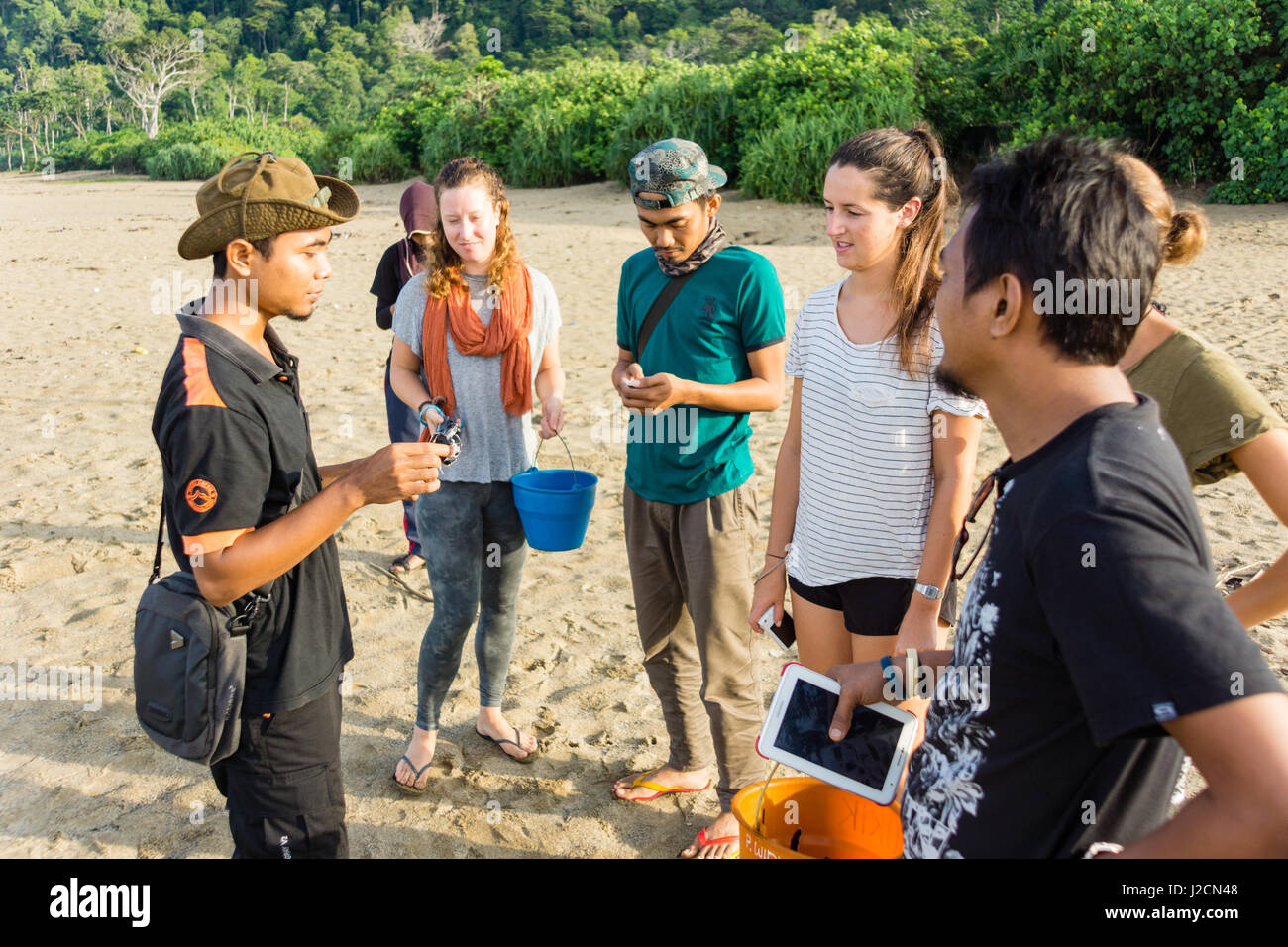 Indonesia, Java Timur, Kabany Banyuwangi, Meru Betiri National Park, local guides tourists on the beach Stock Photo