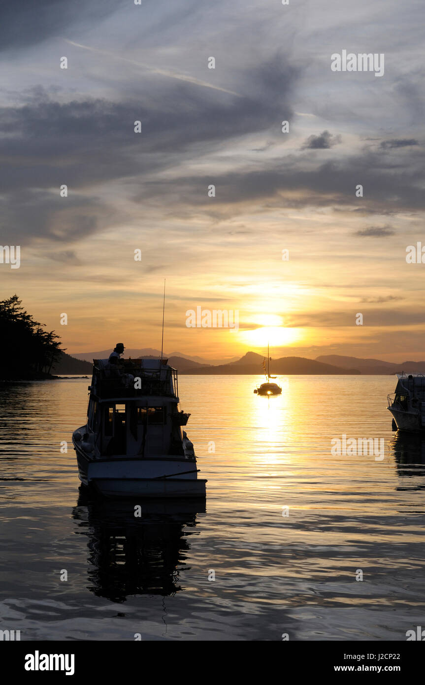 Canada, British Columbia, Cabbage Island. Boats at anchor at sunset