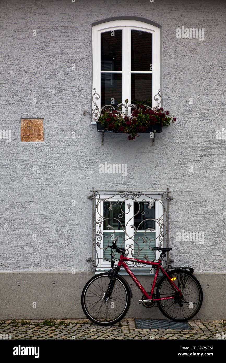 Landsberg am Lech, Germany. Bicycle leans against a wrought iron ornate window and building Stock Photo