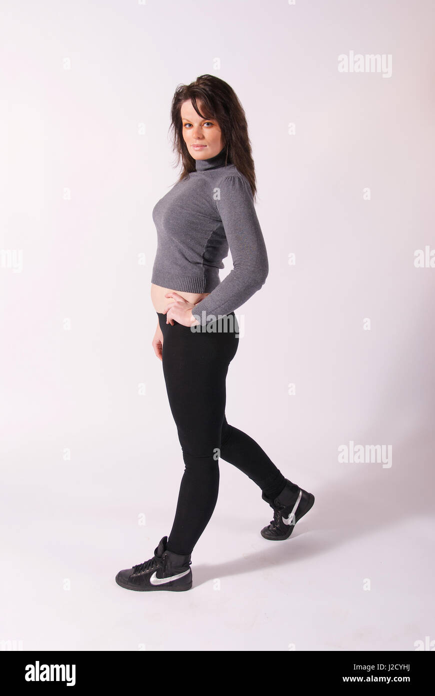 Fotografia do Stock: Beautiful brunette girl in black leggings and