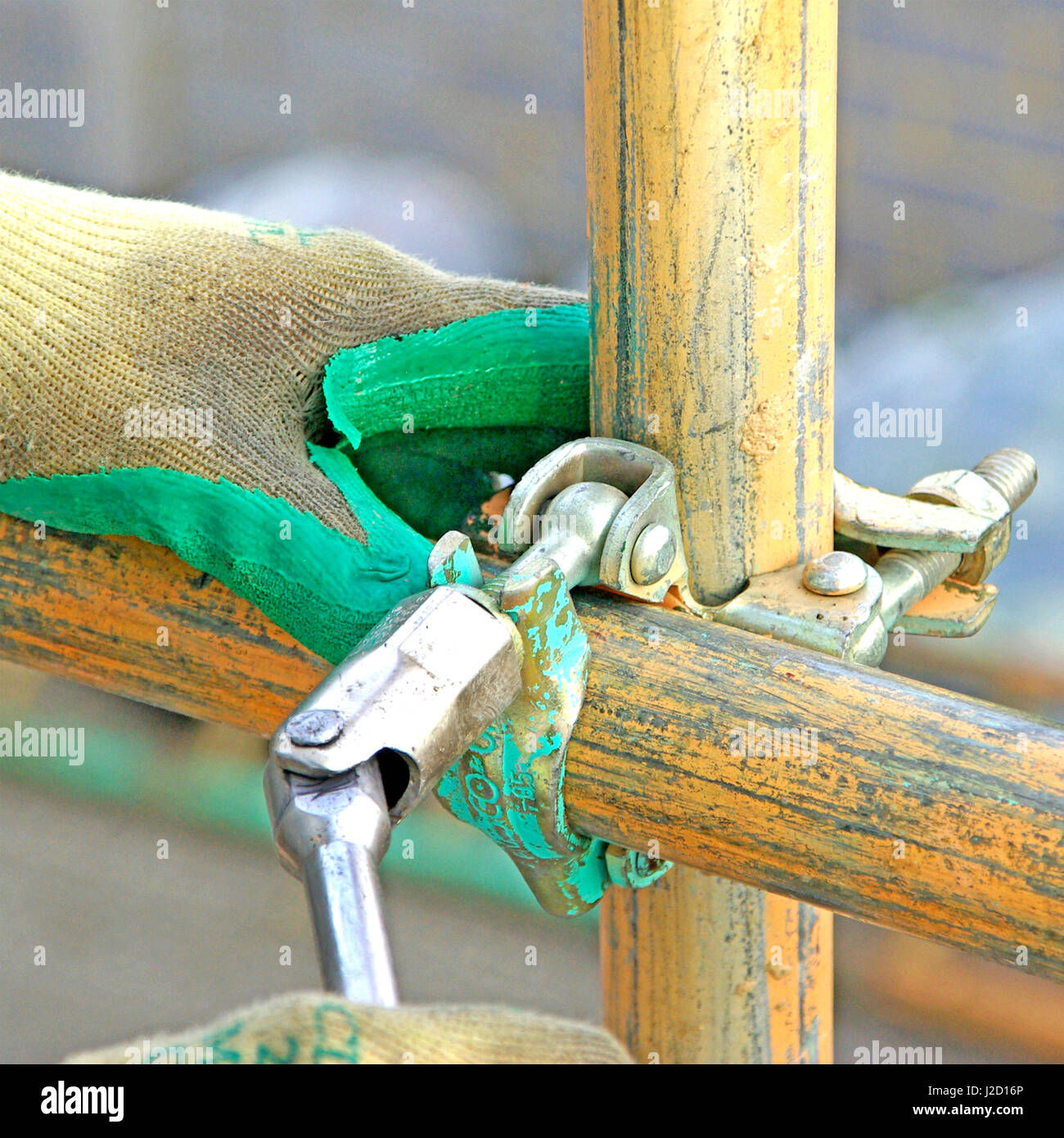 Scaffolding tools close up glove hand using spanner close up concept