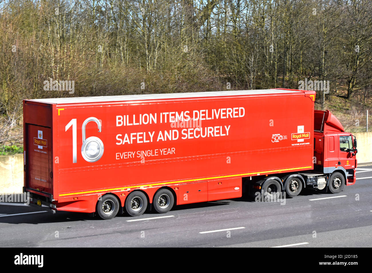 UK motorway Royal Mail lorry trailer promoting delivering billion parcels & billions of letters a year & celebrating 50 business years on truck side Stock Photo