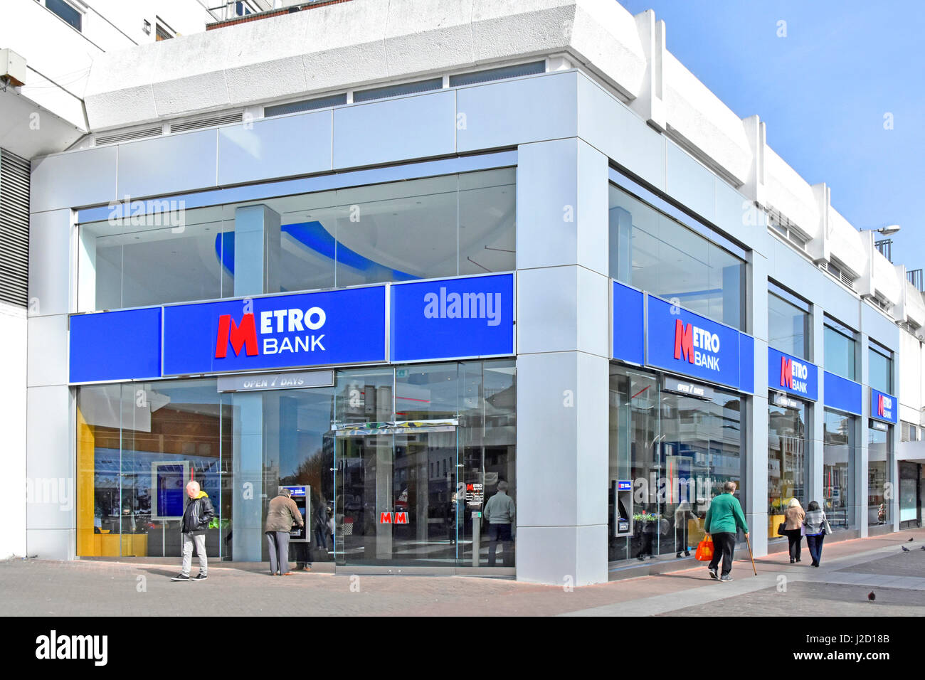 Metro Bank branch signs and logos on a corner site High Street Southend on Sea Essex England UK atm cash point machines located in glass shop front Stock Photo