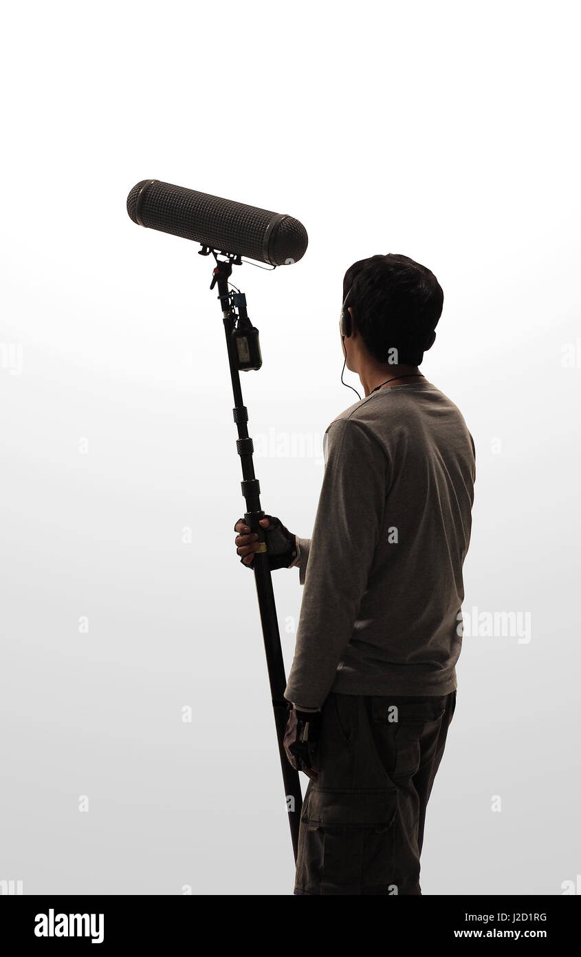 Boom Microphone hold up high by video or film production crew team man and  recording sound for movie in a big studio Stock Photo - Alamy