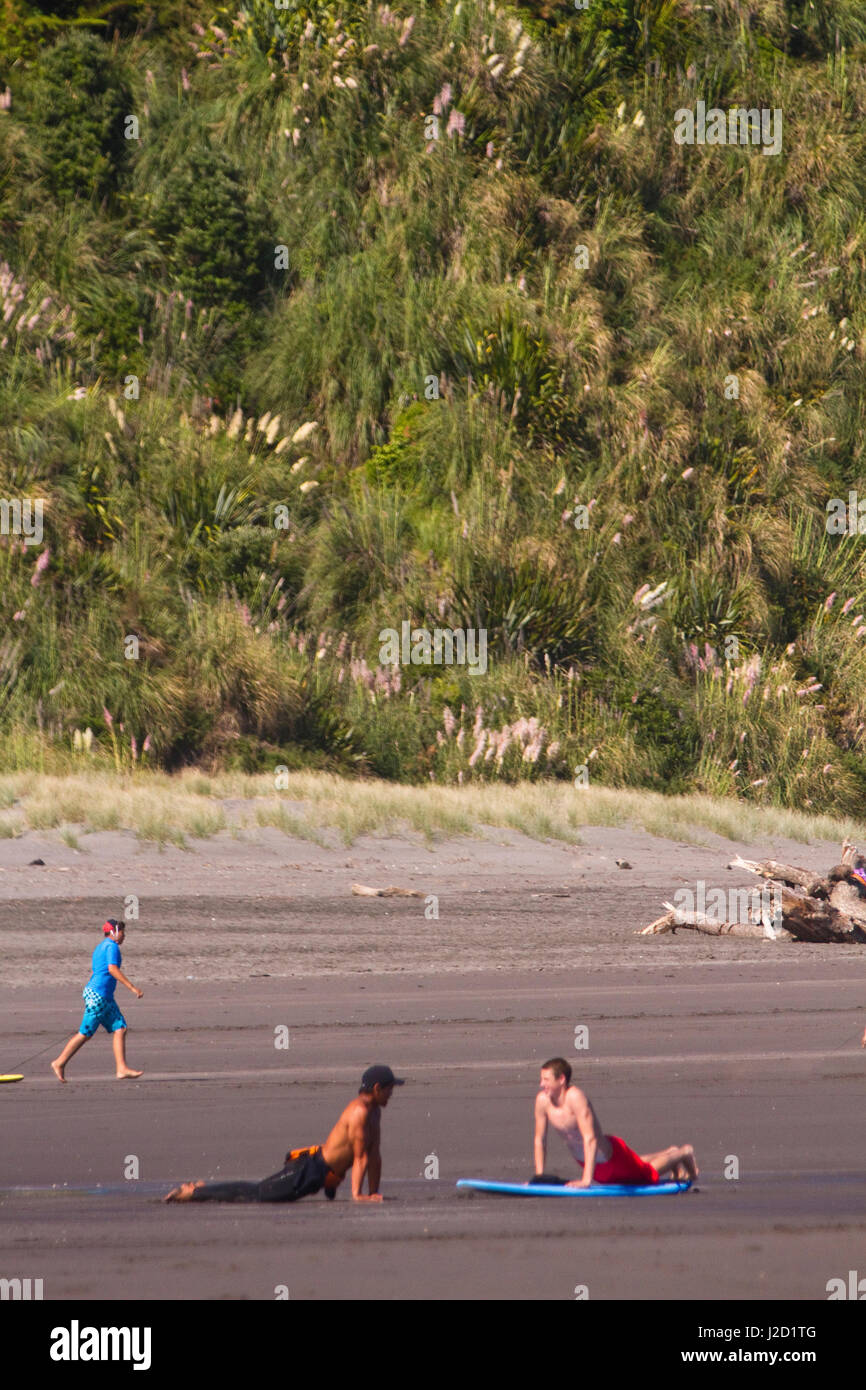 Surf school instructors give their surf students pointers on how to improve in Raglan, New Zealand. Stock Photo