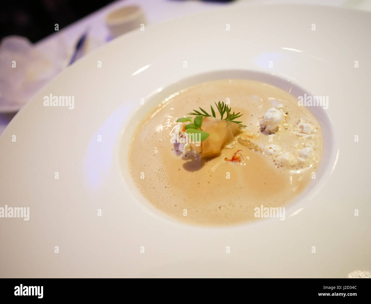 Lobster Bisque with popcorn are served in fine dining restaurant Stock