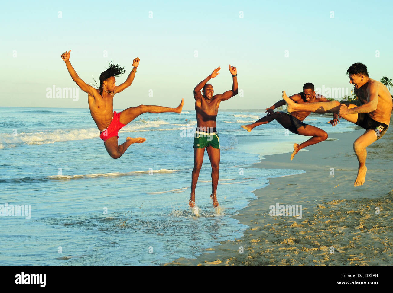 Cuba, La Havana, 4 friends having fun on the beach Stock Photo