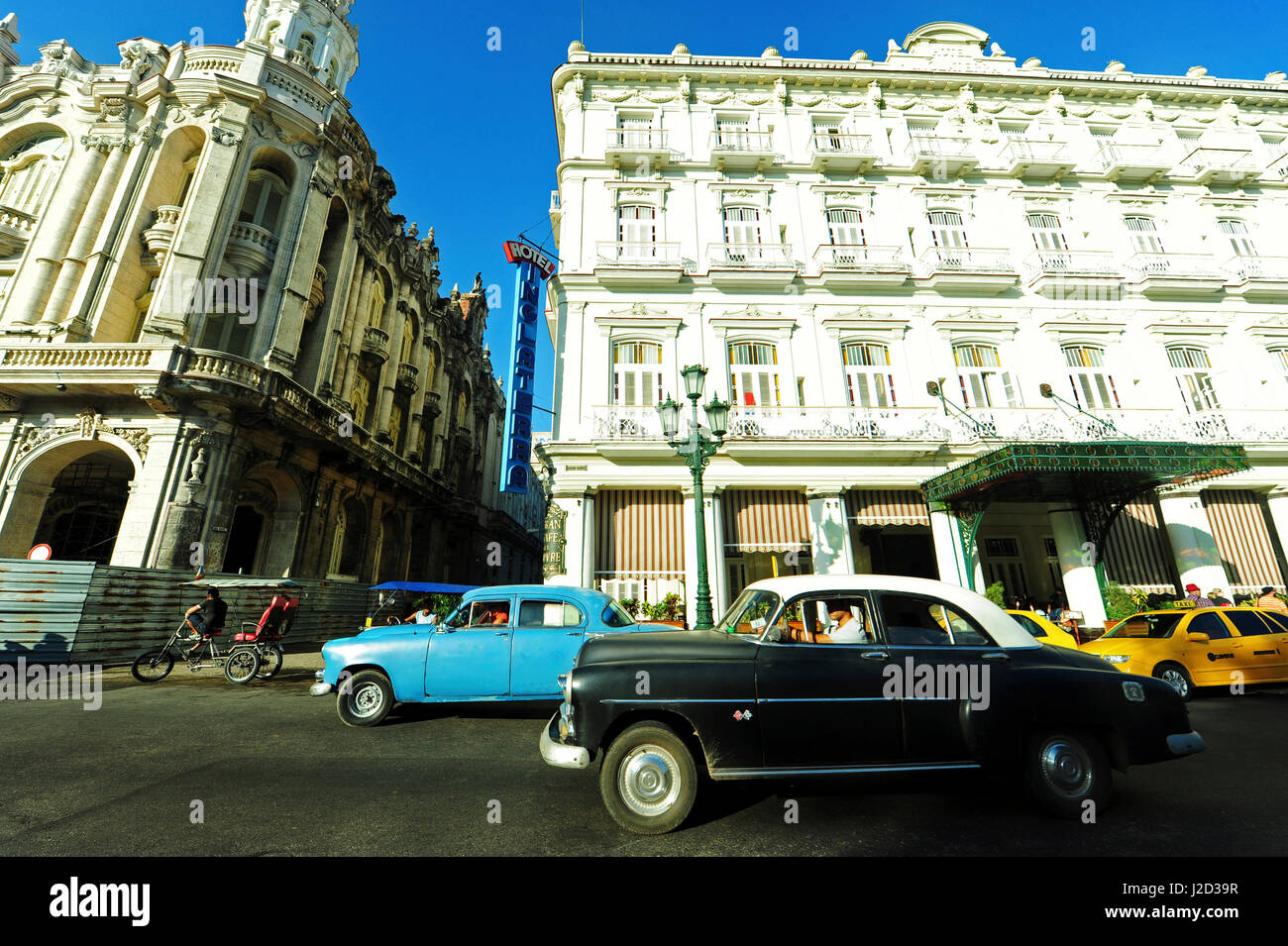 Cuba, La Havana, Hotel Inglaterra, old American cars driving through colonial streets Stock Photo