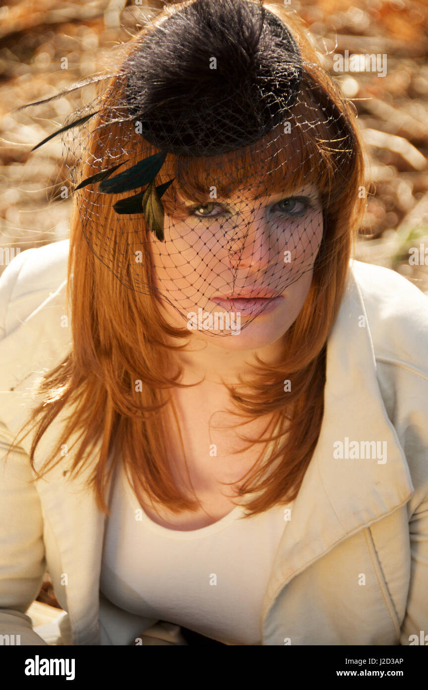 Beautiful Ginger Haired Girl Wearing A Fascinator Head Shot