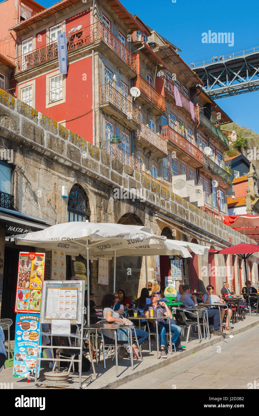 Bar Porto Portugal, view of tourists at a bar in the Ribeira waterfront area enjoy refreshment on a summer afternoon, Porto Europe Stock Photo