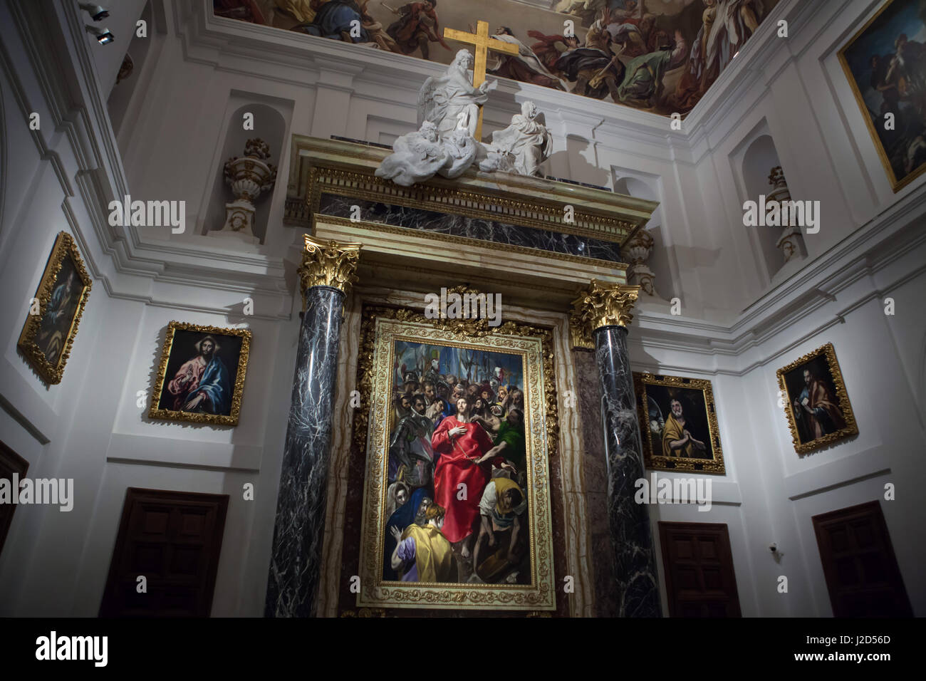 Painting 'Disrobing of Christ' ('El Expolio de Cristo') by Spanish mannerist painter El Greco (1577-1579) on display in the High Altar of the sacristy of the Toledo Cathedral in Toledo, Spain. Paintings 'Jesus Christ' (L) and 'Tears of Saint Peter' (R) also by El Greco (1605-1610) are displayed right and left. Other paintings by El Greco from the Apostolados series are displayed on the side walls. Stock Photo