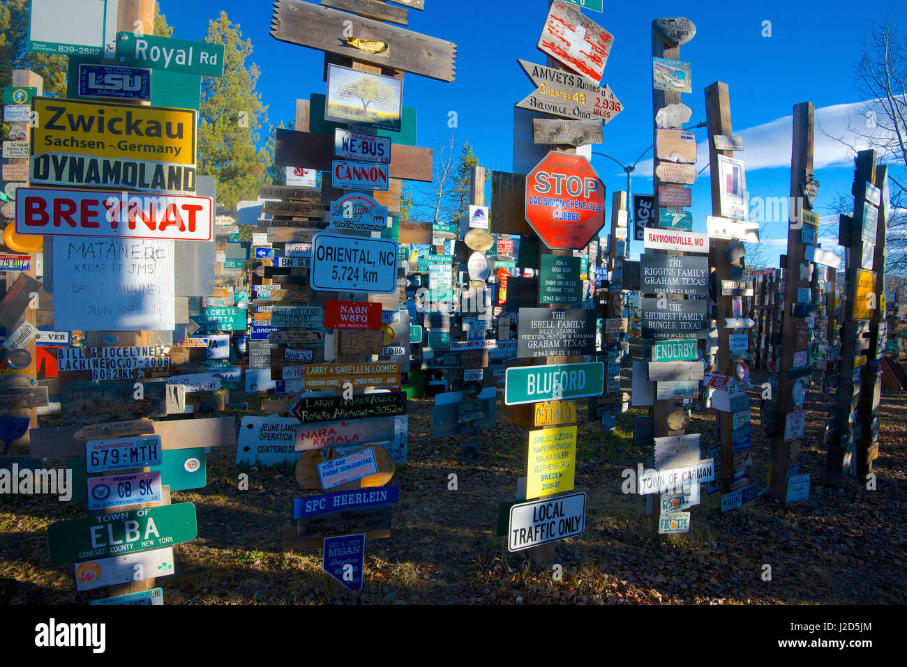 The Yukon's Watson Lake Sign Post Forest, begun in the 1940s when US Army soldiers tacked up hometown signs, has grown to thousands of signs. (Large format sizes available) Stock Photo